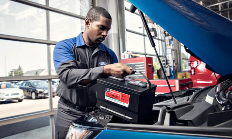 Ford technician replacing a car battery