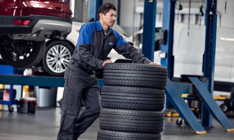 Technician with car tires