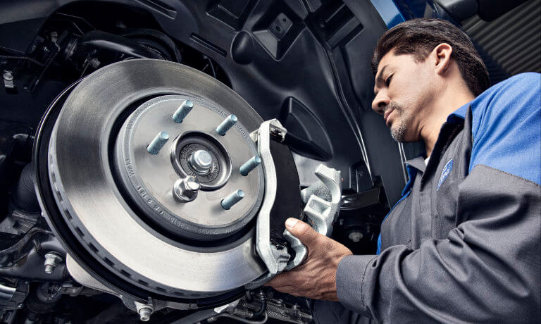 Ford technician replacing brake pads