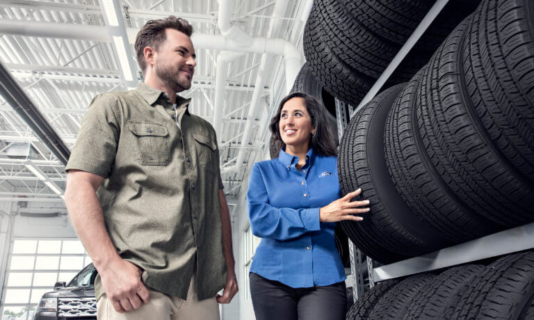 Ford specialist showing tires to a customer