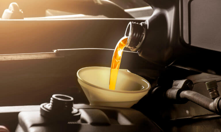 Oil being poured into a car